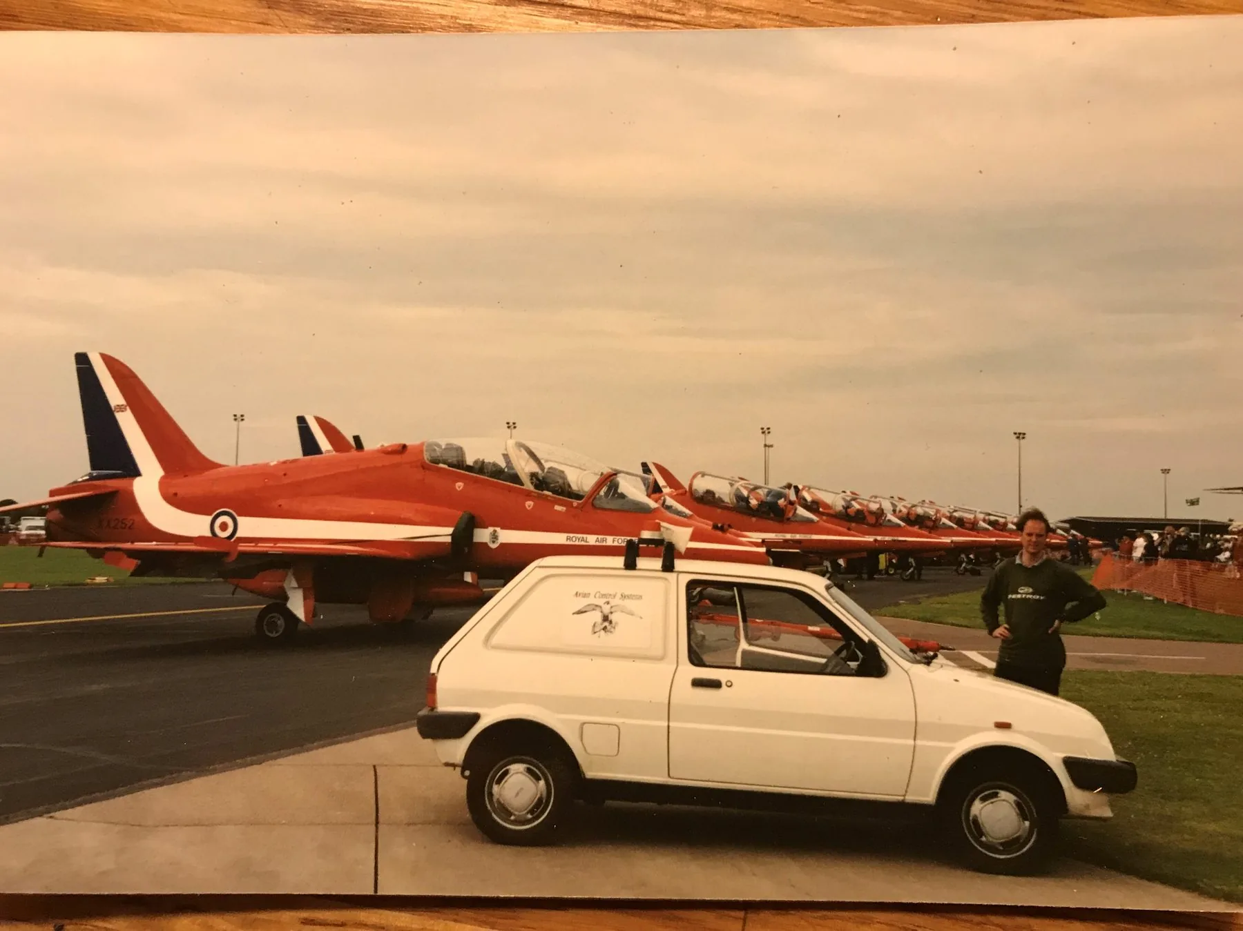 Avian Control System bird-control vehicle on the runway at RAF Mildenhall Airshow — Red Arrows lined up behind